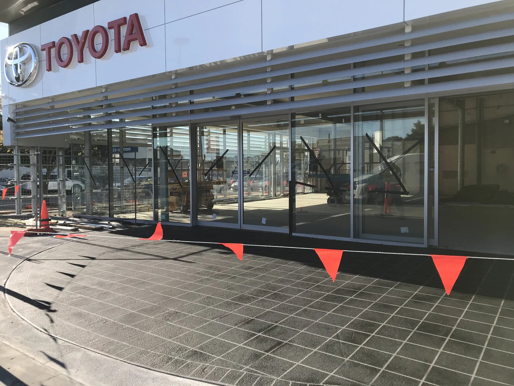 The same dealership forecourt finished in a grey stencil tile pattern